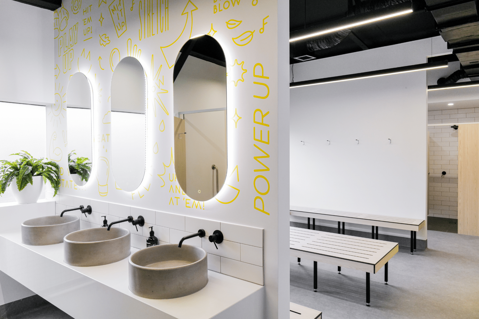 Chic, fresh changerooms at Upstate Studios fitness studios. Bright interior with pops of yellow colour create an uplifting atmosphere after working out.