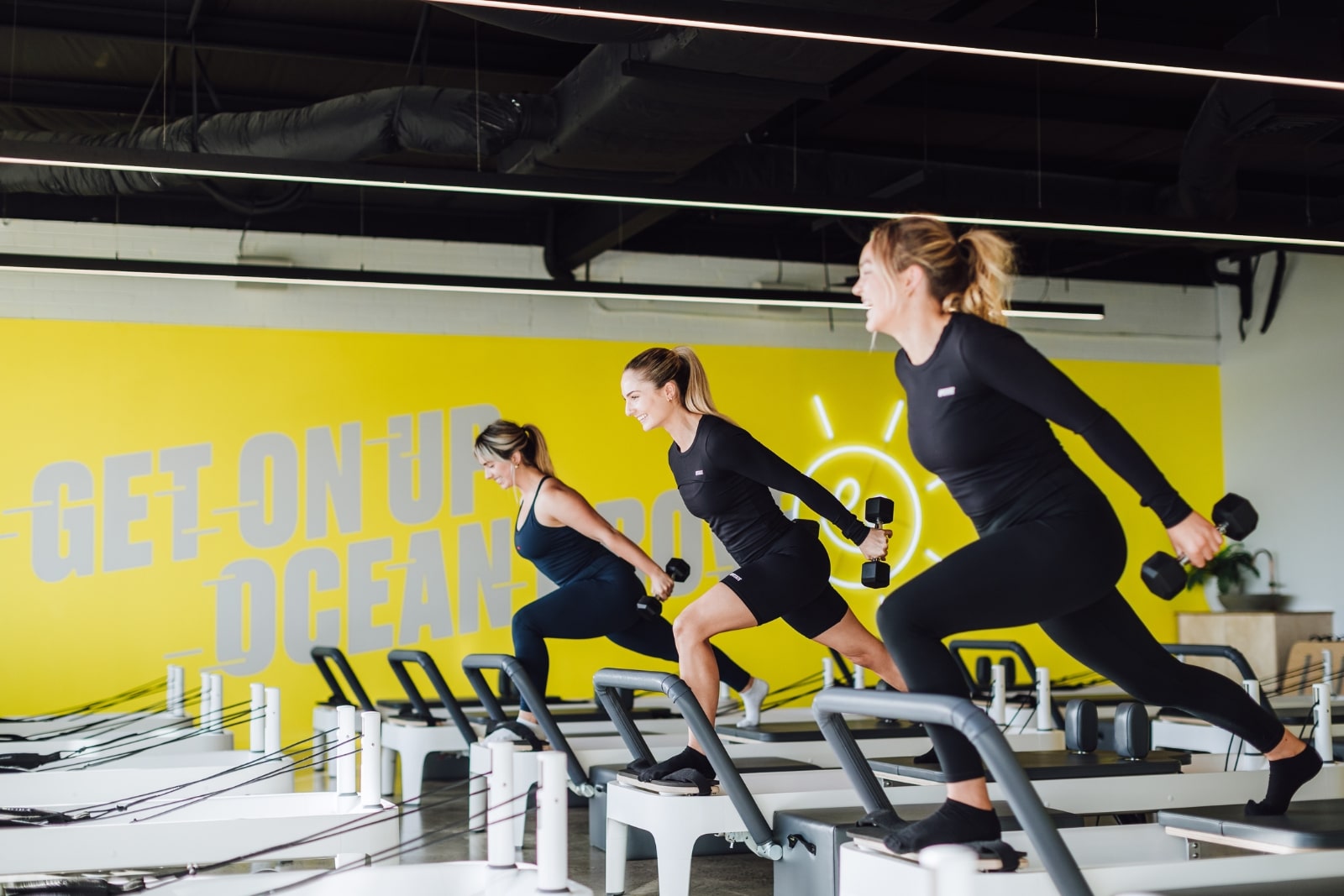 girls on a reformer bed with weights